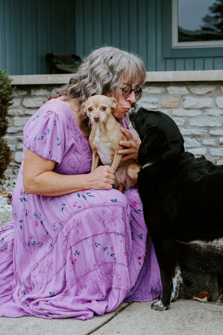 Connie Klar, Fear Free Certified Professional, sitting with her own dogs