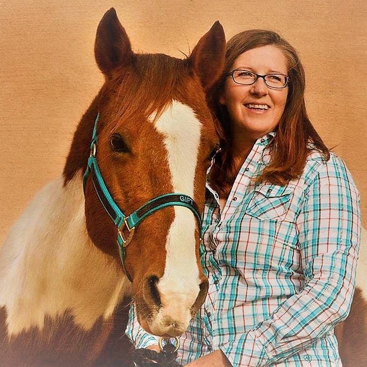 Lorrin Maughan standing with her horse Gift